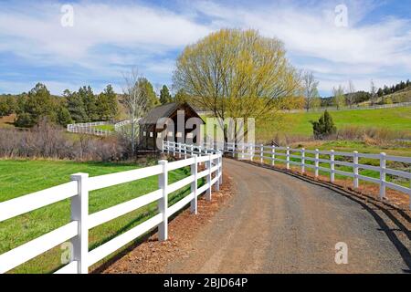 A small covered bridge over a creek in the John Day region of central Oregon on the eastern slope of the Ochoco Mountains. Stock Photo