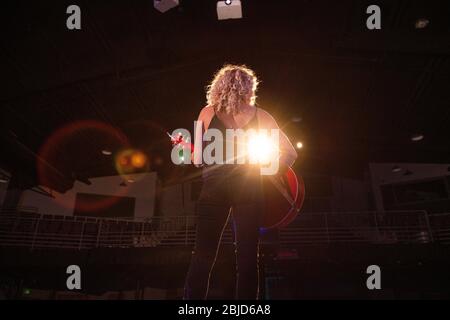 Female musician playing music on stage Stock Photo