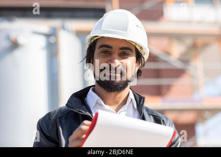 civil engineer  working outside with helmet and plan Stock Photo