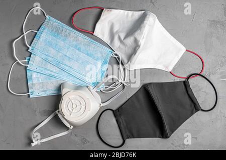 different protective masks on a gray concrete background Stock Photo
