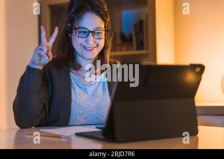 Woman working at home. working with a computer. Woman in a video call from home having fun Stock Photo