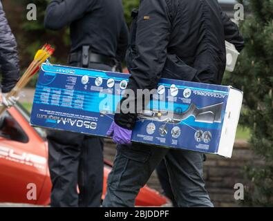 Gelsenkirchen, Germany. 29th Apr, 2020. An investigator walks out of the suspect's apartment with a cardboard box on which a rifle is depicted. A police officer was killed during a SEK operation in Gelsenkirchen on Wednesday morning. Credit: Bernd Thissen/dpa/Alamy Live News Stock Photo