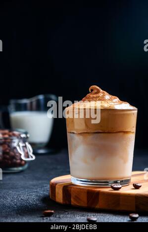 Iced Dalgona Coffee on Dark Background. Trendy Creamy Whipped Coffee. South Korean Cold Summer Drink. Stock Photo