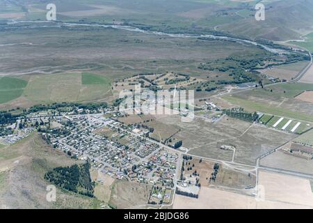 aerial, from a glider, of another glider flying over village and nearby golf course, shot in bright spring light at Omarama, Canterbury, Otago, South Stock Photo