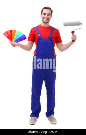 Young decorator holding color samples and paint roller, on white background Stock Photo