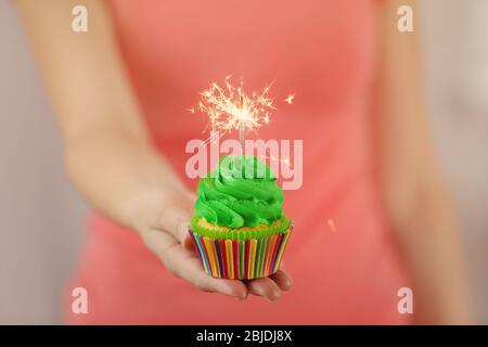 Woman holding tasty cupcake, closeup Stock Photo