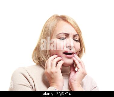 Senior woman suffering from toothache on white background Stock Photo