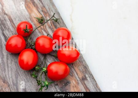 Piccadilly tomato bunch. Fresh juicy sweet tomatoes for traditional Mediterranean cuisine. Top view. Space for text. Stock Photo