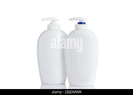 two cosmetic mock up bottles isolated on white background. jar for skincare product cream, shampoo, conditioner, foam. Empty, clean white plastic bottles with pump dispenser Stock Photo
