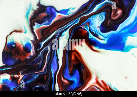 Background of milk and colored diluted paints in it Stock Photo