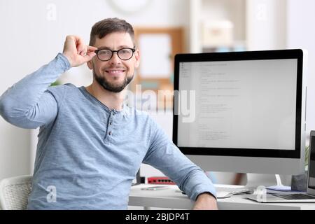 Handsome young programmer working in office Stock Photo