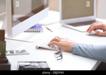 Hands of programmer working with computer in office Stock Photo