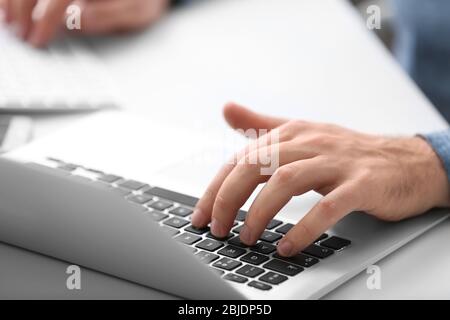 Programmer working with laptop in office, closeup Stock Photo