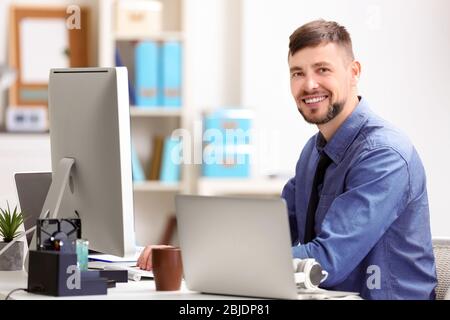 Handsome young programmer working in office Stock Photo