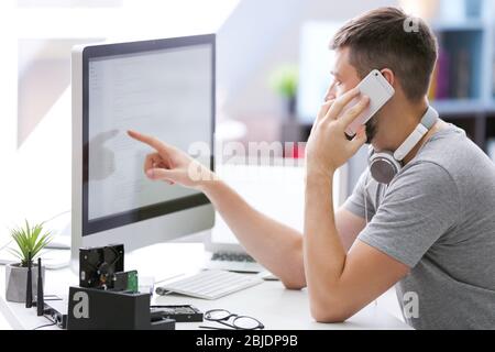 Handsome young programmer working at home Stock Photo