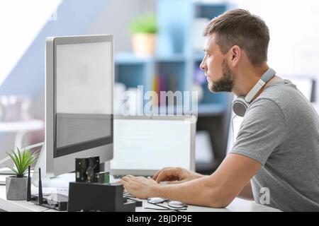 Handsome young programmer working at home Stock Photo