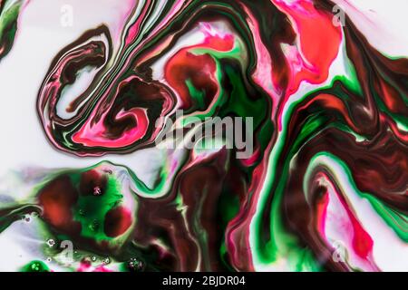 Background of milk and colored diluted paints in it Stock Photo