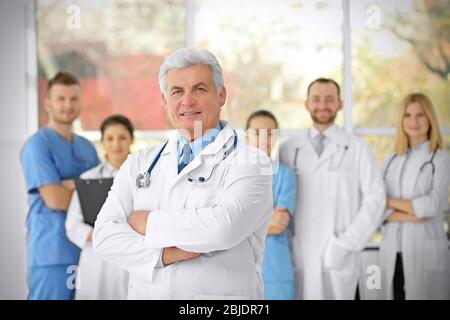 Senior handsome doctor in clinic Stock Photo