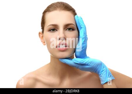 Hands touching female face on white background. Plastic surgery concept Stock Photo