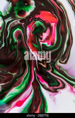 Background of milk and colored diluted paints in it Stock Photo