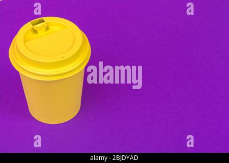 Takeaway cup of coffee on bright colored background Stock Photo