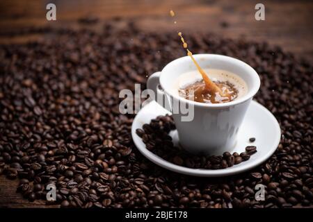 Drops of coffee splashing in a coffe milk, high speed close up Stock Photo