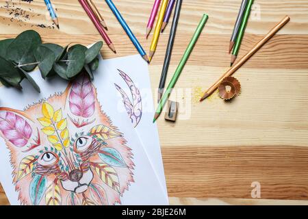 Composition of coloring and pencils on wooden table Stock Photo