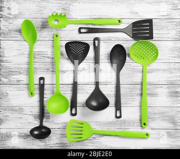 Set of different kitchen tools on wooden table Stock Photo