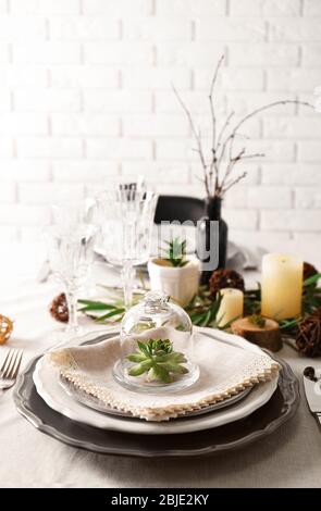 Table served with succulents for dinner in living room Stock Photo