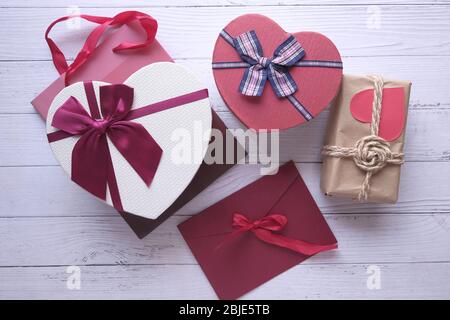 Different colorful gift boxes on wooden background. Stock Photo