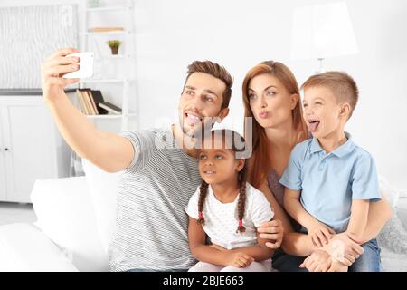 Happy interracial family making selfie at home Stock Photo