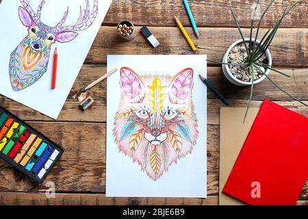 Colouring pictures and pencils on wooden table Stock Photo