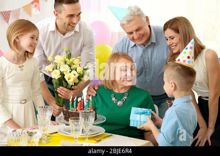 Family celebrating grandmother's birthday together Stock Photo