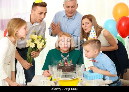 Family celebrating grandmother's birthday together Stock Photo