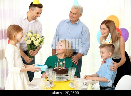 Family celebrating grandmother's birthday together Stock Photo