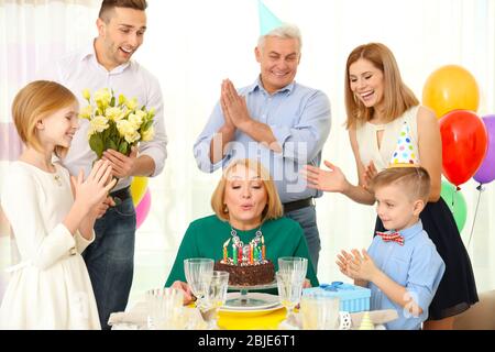 Family celebrating grandmother's birthday together Stock Photo