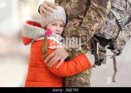 Little girl and her father in military uniform outdoors Stock Photo