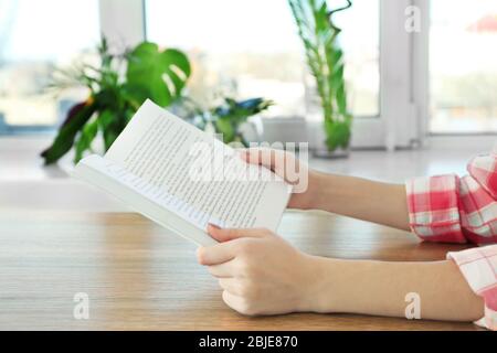 Closeup of woman holding opened book Stock Photo
