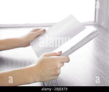 Closeup of woman holding opened book Stock Photo