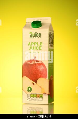 The Juice company Apple juice carton drink isolated on a spring yellow background with reflection. Stock Photo