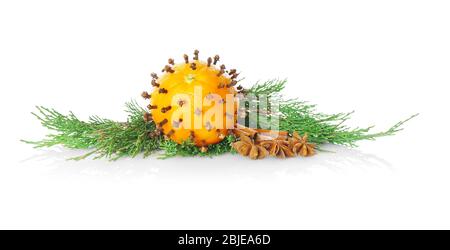 Composition of orange, spices and coniferous branch on white background Stock Photo