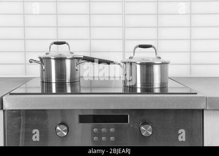 Two saucepans on electric stove in kitchen Stock Photo