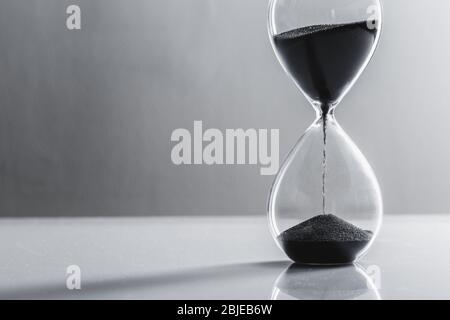 Close up hourglass on table. Close up. Stock Photo