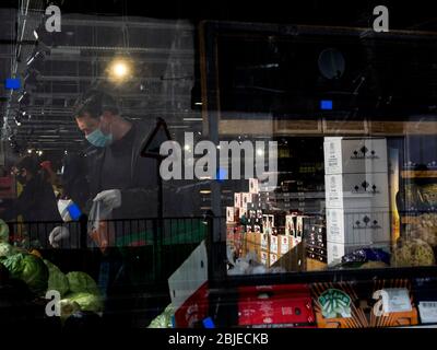 Leytonstone, London. UK. April the 29th, 2020. Close-up of man with mask and gloves shopping vegetables. Stock Photo