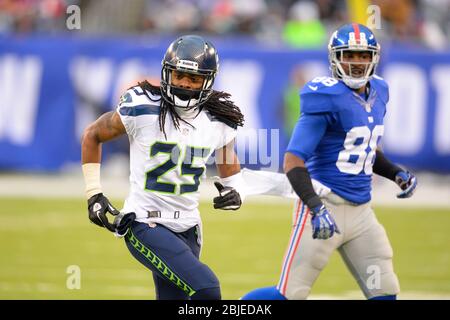 Seattle Seahawks cornerback Richard Sherman, left, begins to take off the  jersey that belongs to injured wide receiver Sidney Rice, right, after  Sherman wore it as a joke during NFL football training