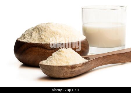 Full  fat powdered milk in wooden spoon isolated on white Stock Photo