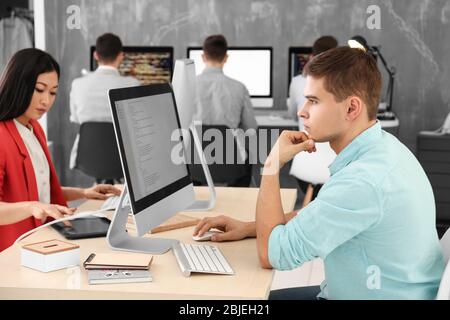 Young programmers working in office Stock Photo