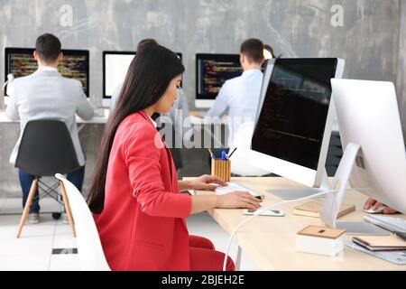 Young programmer working in office Stock Photo