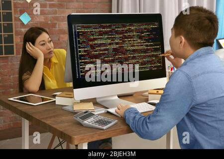 Young programmers working in office Stock Photo
