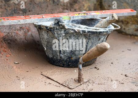 Construction tools background, bucket trowel and level . Stock Photo